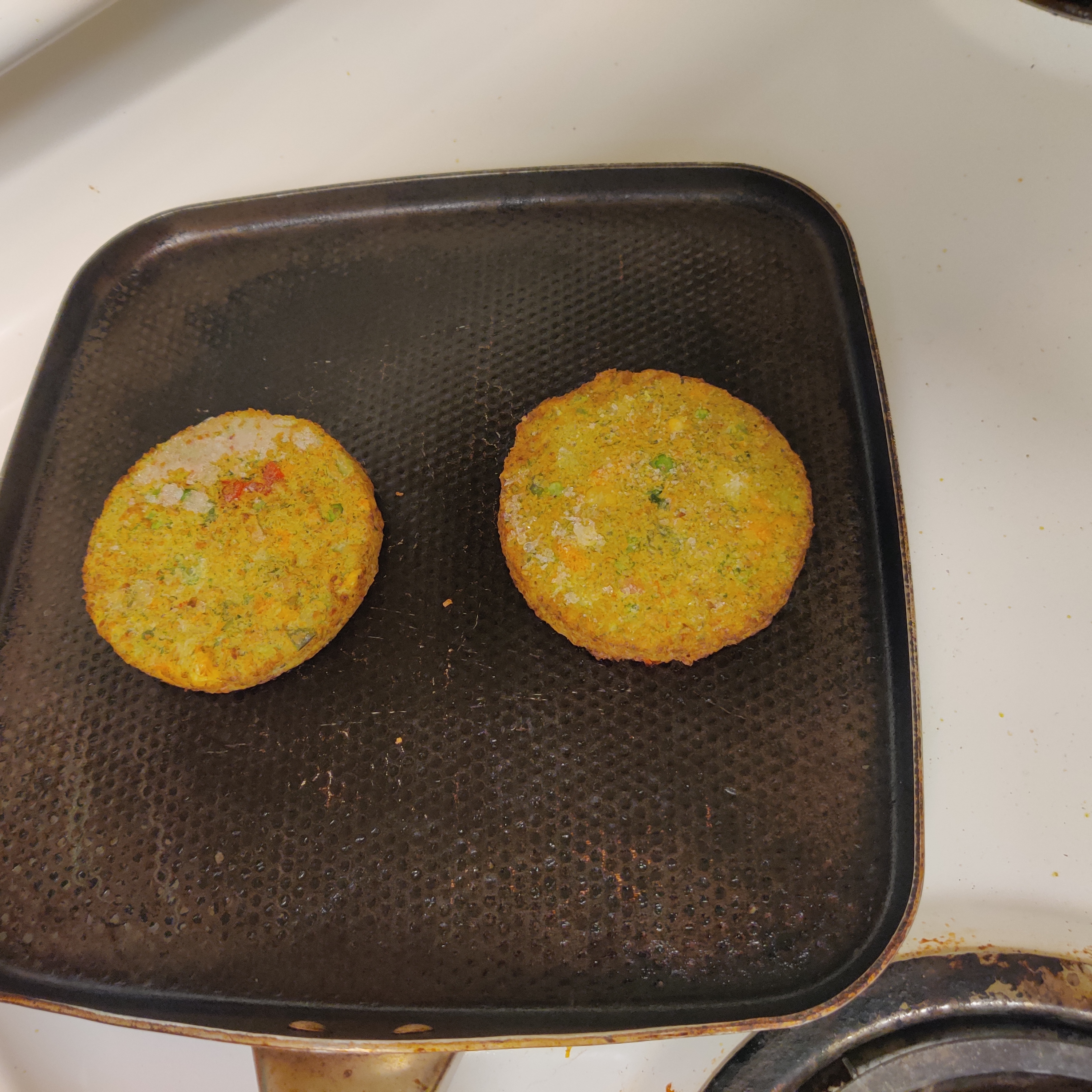 Image of heating burgers on pan